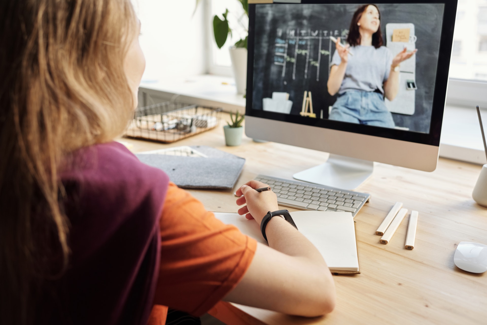 Frau vor Bildschirm Onlineveranstaltung